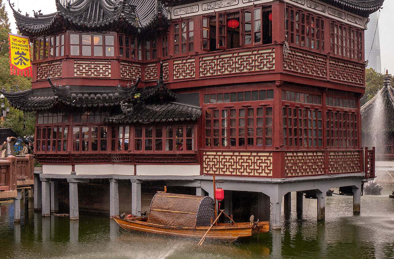 The Huxinting Teahouse and zigzag bridge at the Yu Garden pond